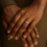 a black man's hand clasped with a black woman's hand